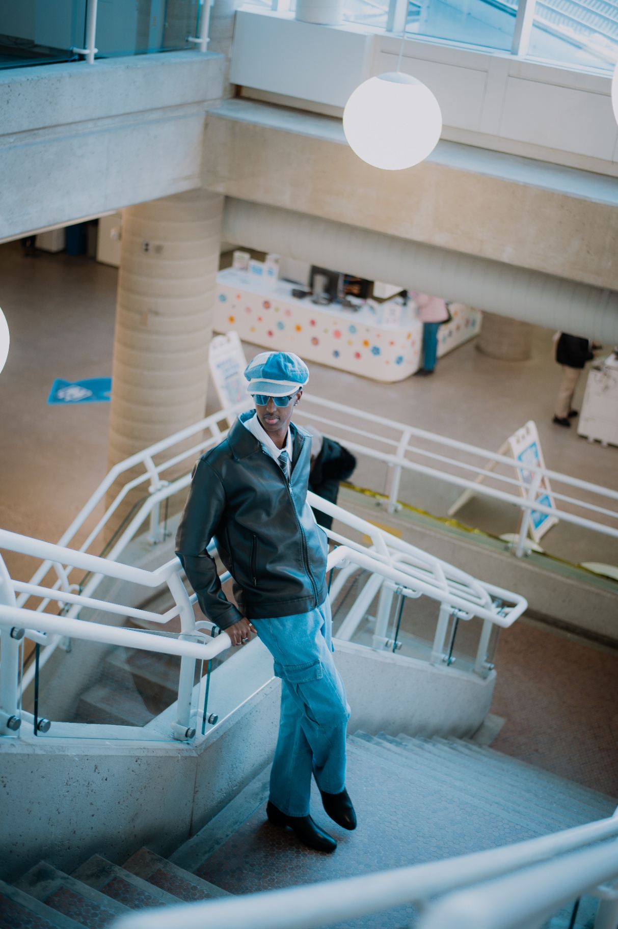 Standing tall on the library staircase in full outfit